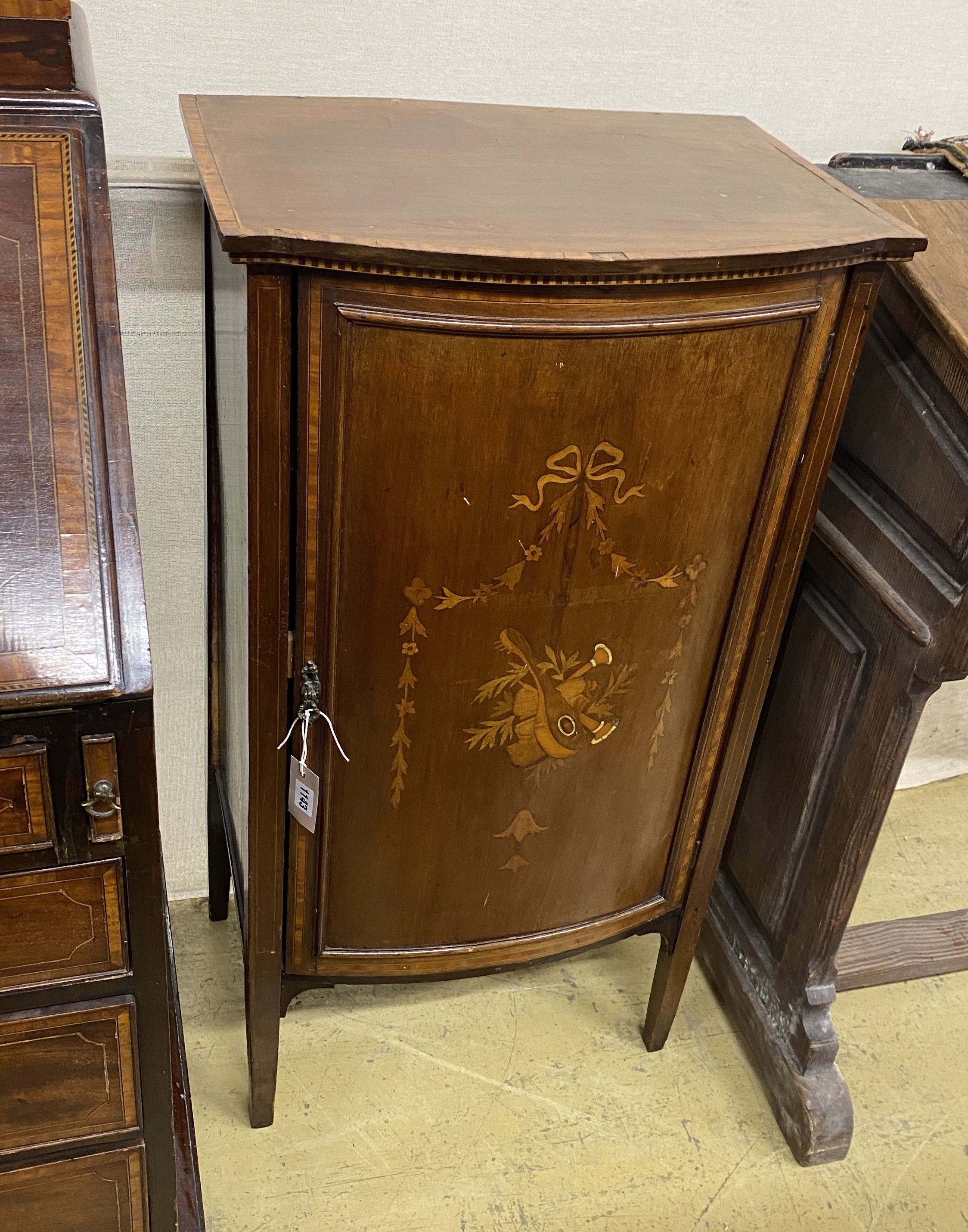 An Edwardian satinwood banded marquetry inlaid mahogany bow front side cabinet, width 53cm, depth 38cm, height 100cm